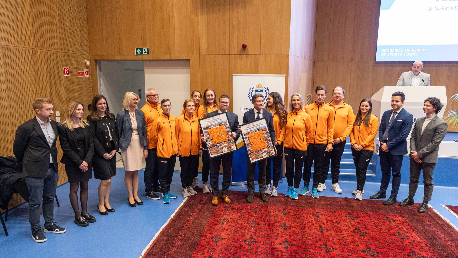 Volunteers of the 2023 World Athletics Championships present gift to Sebastian Coe  
